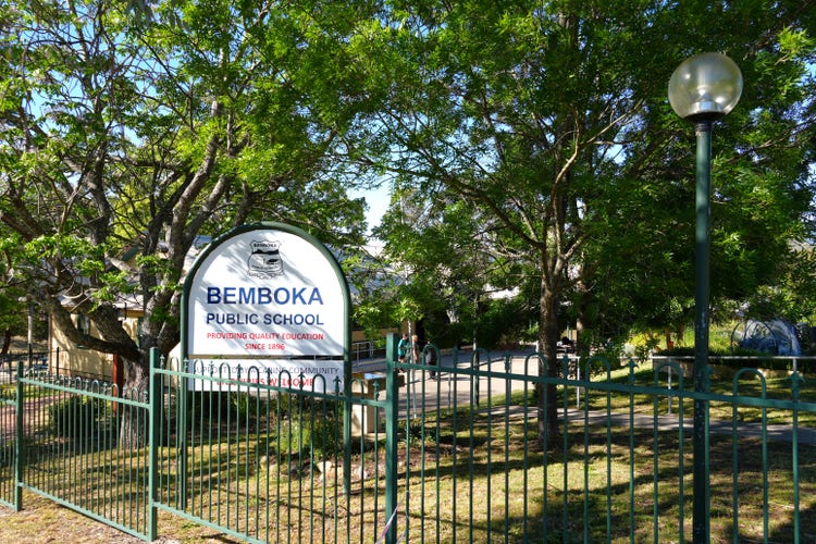 school gates with school sign