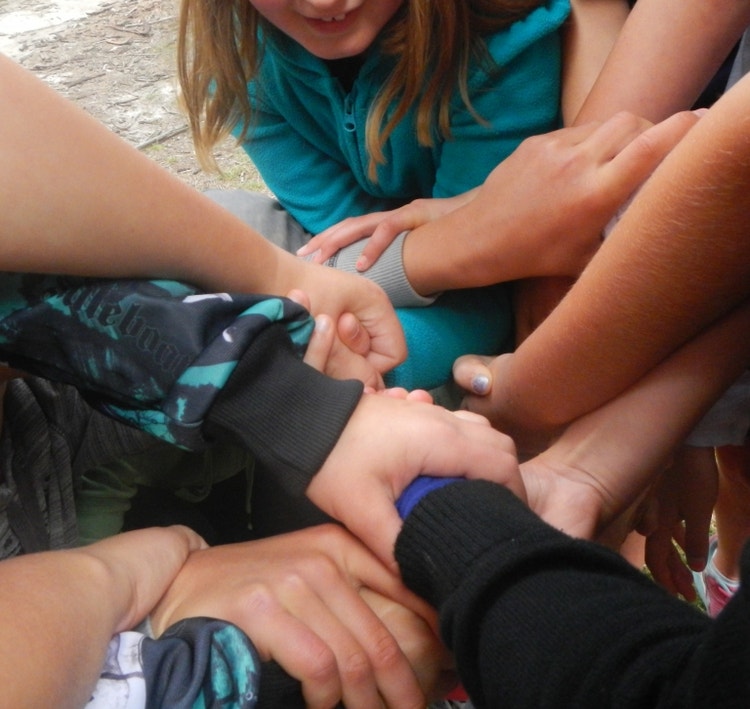 Group of student hands interlocking