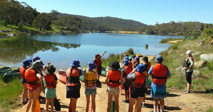 Jindabyne Sport and Recreation Centre students in front of the lake with backs to the camera